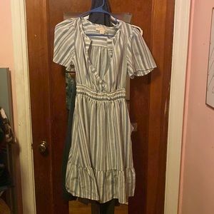 It’s a casual light blue and white striped dress, good for beach trips.